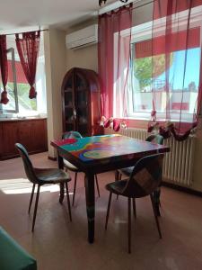 a dining room with a table and chairs in a room at Casa Paola in Numana