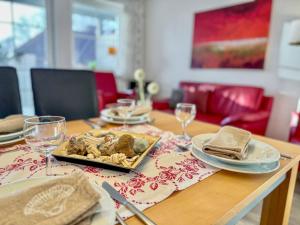 a wooden table with a plate of food on it at "Landhaus Voss" Typ 2 Nr8 in Staberdorf