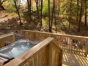 a hot tub on a deck on a porch at Stairway to Heaven in Birdseye
