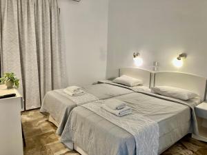 A bed or beds in a room at Hotel Apartments Panorama
