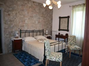 a bedroom with a bed and two chairs at Casa Vacanze Cimorelli in Venafro +71 photos