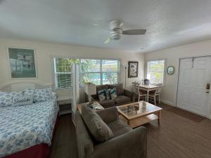 a living room with a couch and a table at Bahama Beach Club Pompano - Fort Lauderdale - Charming and Cozy Studios & Apartments close to Beach with Pool in Pompano Beach +101 photos