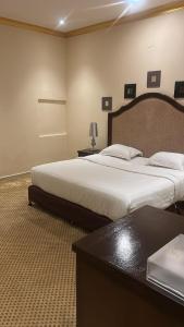 Postel nebo postele na pokoji v ubytování Aseel Hotel Apartment
