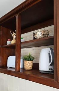 a kitchen shelf with two toasters and a toaster at JB House in Peniche