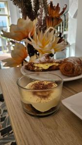 a table with a bowl of food and a vase of flowers at Hotel Camelia in Rimini