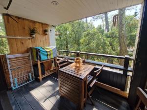 a screened in porch with a table and chairs at 450m plage Bourdaines in Seignosse +4 photos