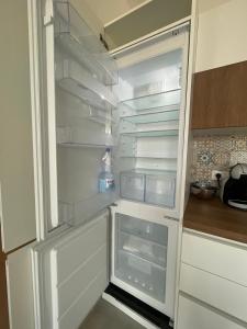an empty refrigerator with its door open in a kitchen at Francy s Marzamemi Home in Marzamemi