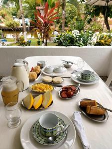 a white table with plates of food on it at Restaurante e Petiscaria Tucunaré Azul in Coruripe +9 photos