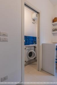 a bathroom with a washing machine in a room at Suite Giò in Savelletri di Fasano