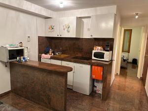a kitchen with white cabinets and a microwave at Bartholomé LE MAGNIFIQUE in Drancy +36 photos
