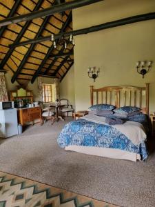 a bedroom with a large bed in a room at Kudu Crescent Guesthouse in Harrismith