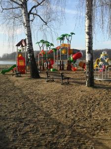 a park with a playground with trees and slides at Skorzęcin Przytulny Zakątek in Skorzęcin
