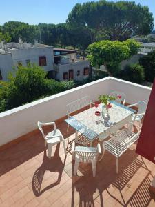 a patio with a table and chairs on a balcony at Casa Paola in Numana +17 photos