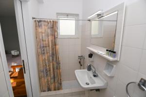 a bathroom with a sink and a shower at Kanali Apartments in Kanali +53 photos