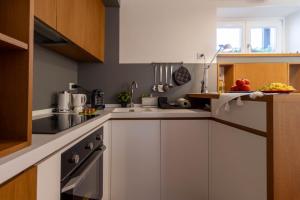 a kitchen with white cabinets and a sink at Casa Venezia San Nicola in Bari +30 photos