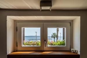 an open door with a view of the ocean at Casa Venezia San Nicola in Bari