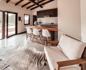 a kitchen and living room with a table and chairs at apartamento campestre con terraza in Puerto Varas