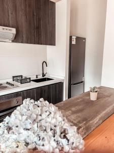 a kitchen with a stainless steel refrigerator and a counter top at apartamento campestre con terraza in Puerto Varas