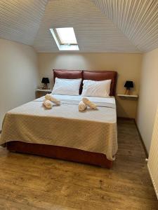 a bedroom with a bed with two towels on it at Gano Appartement in Katerini +32 photos