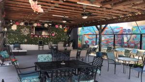 a dining room with tables and chairs and a mural at Hotel Casa Victoria in Puerto Peñasco