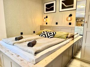 a bedroom with a large bed on a wooden platform at Monte Poddasze I Ciasna ale wanna I 5 minut plaża in Sopot