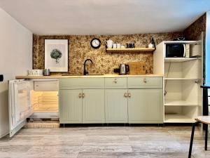 a kitchen with white cabinets and a sink at Monte Poddasze I Ciasna ale wanna I 5 minut plaża in Sopot