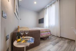 a room with a bed and a table with wine glasses at Rifugio Gianmarco in Florence