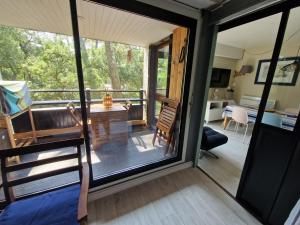 a screened in porch with a view of a room at 450m plage Bourdaines in Seignosse