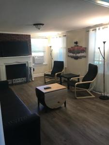 a living room with a couch and chairs and a fireplace at Charming Hudson Valley 3-Bedroom Family Getaway in Tomkins Cove +14 photos