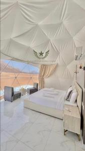 a bedroom with a large bed in a tent at RUM CITY STAR BUBBLE lUXURY CAMP in Wadi Rum
