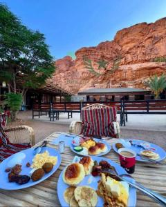 a table with plates of breakfast food on it at RUM CITY STAR BUBBLE lUXURY CAMP in Wadi Rum