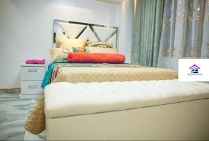 a bedroom with a bed with pillows on it at Premier Elegant Apartments in Harare