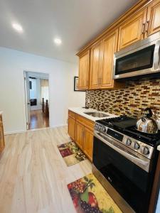a kitchen with wooden cabinets and a stove top oven at Need to relax! Do it here! in Wave Crest