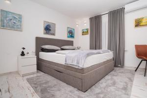 Postel nebo postele na pokoji v ubytování Bogdanović Winery Apartman