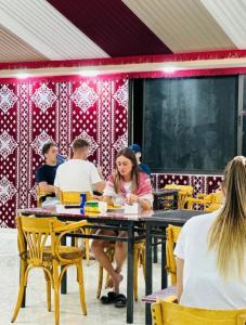 a group of people sitting at a table at RUM CITY STAR BUBBLE lUXURY CAMP in Wadi Rum +36 photos