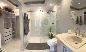 a bathroom with a shower and a toilet and a sink at House surrounded by nature in Cali +8 photos