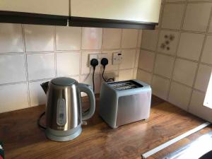 a coffee pot and a toaster on a kitchen counter at Central with River Views in Chesterton