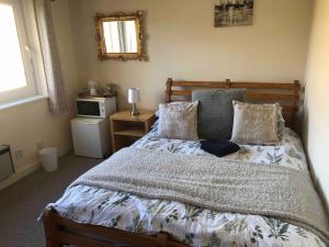 a bedroom with a large bed with pillows at Central with River Views in Chesterton +12 photos