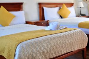 Postel nebo postele na pokoji v ubytování Hotel Coronel