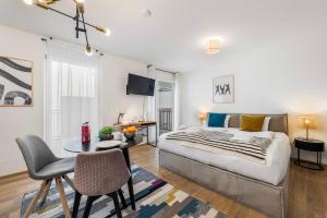 a bedroom with a bed and a table with a chair at Vienna Hills Living in Vienna