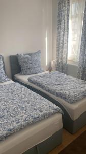 two beds sitting next to each other in a bedroom at O Graham 3 people 2 rooms in Markranstädt