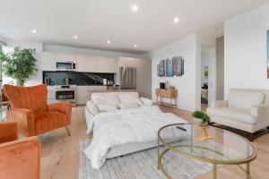 a living room with a white couch and a glass table at Ocean View Luxury Living in Carlsbad