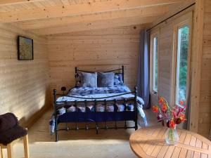 a bedroom with a bed in a log cabin at Hiraeth y Bryn in Capel-Curig