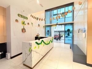 a lobby of a restaurant with a counter with green plants at Colony Service Suites Kuala Lumpur in Kuala Lumpur +35 photos