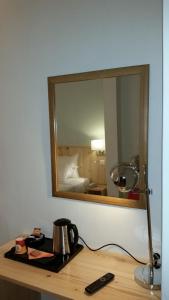 a bathroom with a mirror and a sink at Hôtel Le Compostelle in Paris