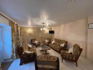 a living room with couches and chairs at Sensation, maison 3 chambres pour 9 personnes in Chuffilly-Roche