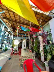 a room with a table and colorful umbrellas and plants at Hostel Torre Bahia in Salvador