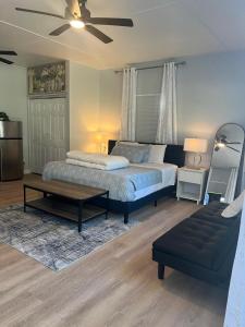 a bedroom with a bed and a table and a couch at Luxurious Super Spacious Home in Tallahassee