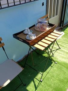 a table with plates of food on it next to a chair at La Cabaña de Morgan, Refugio con alma en el corazón de Galicia in Arnoia