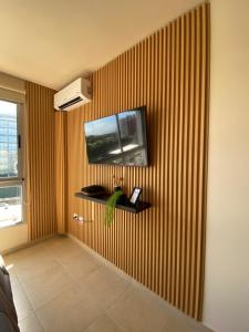 a room with a television on a striped wall at Espacio Arena in Buenos Aires